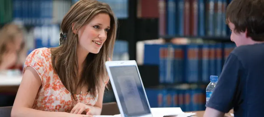 Two students study in main library together
