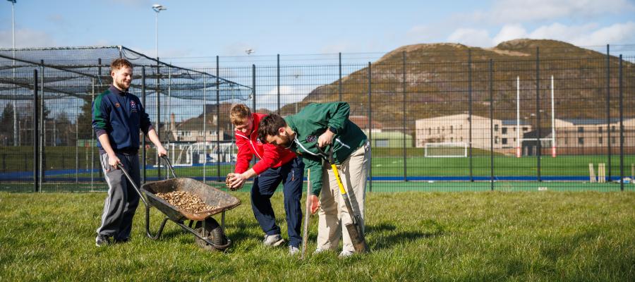 Wild Peffermill - students with wheelbarrow by Andrew Perry