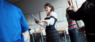 A person in costume reads from a script