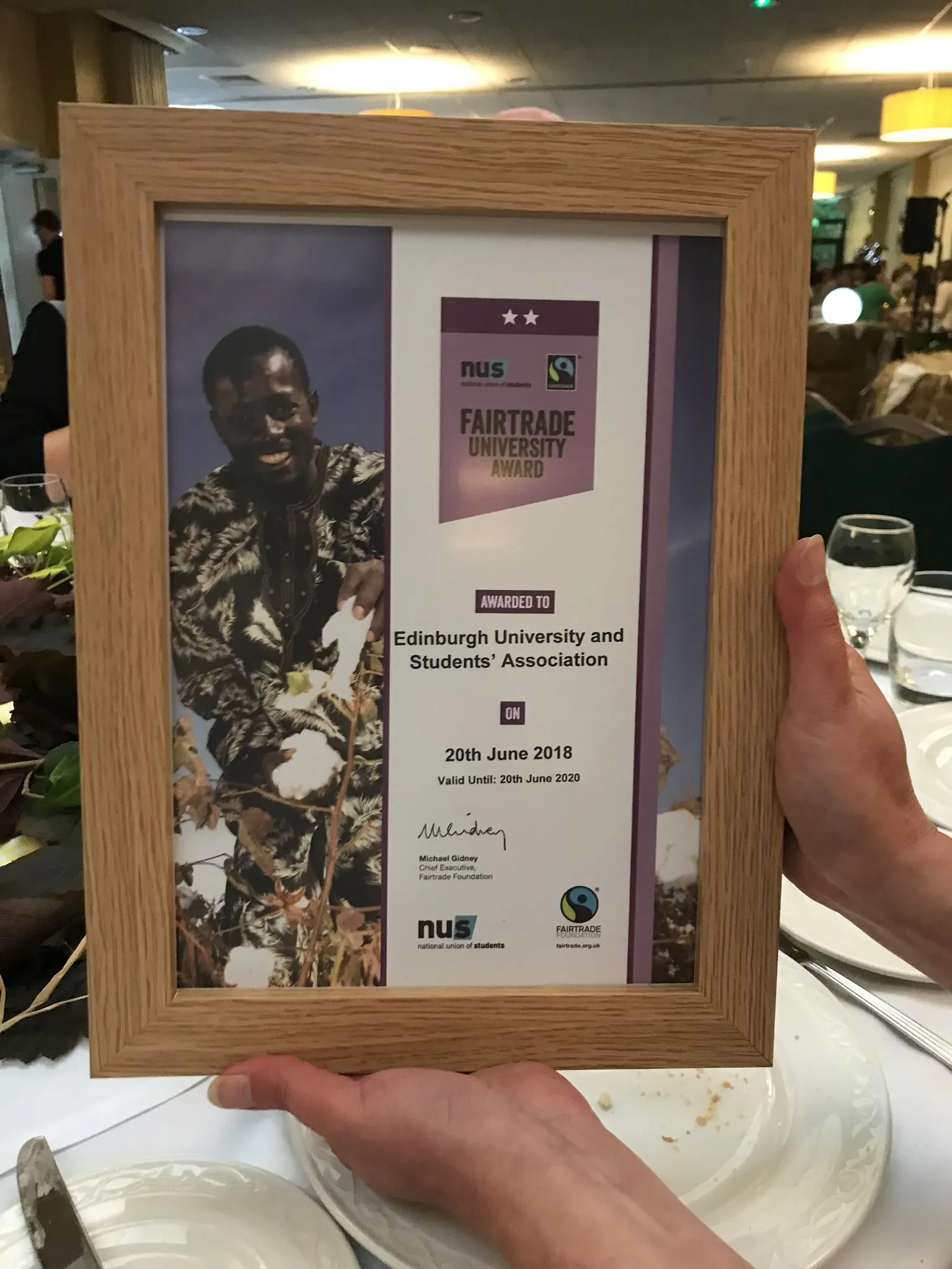 Picture of the University's Fairtrade Award, a plaque with a wooden frame and the logos of the NUS and Fairtrade Foundation