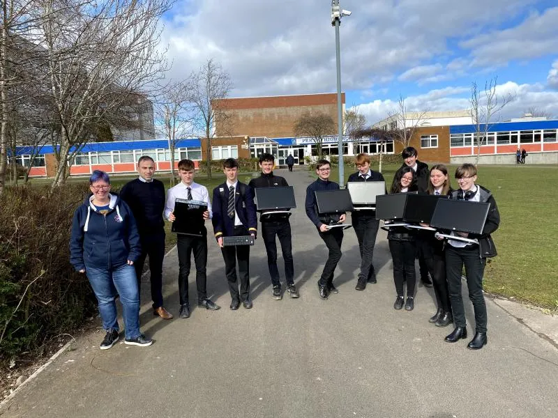School children holding PCs