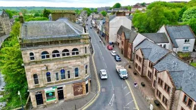 An aerial photo looking down Kilbirnie's Main Street, at the Radio City Association building.