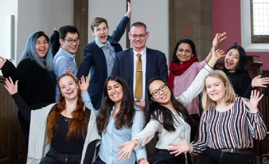 Group of happy students and employer celebrating
