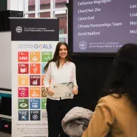 Changemakers hold certificates infont of SDG banner