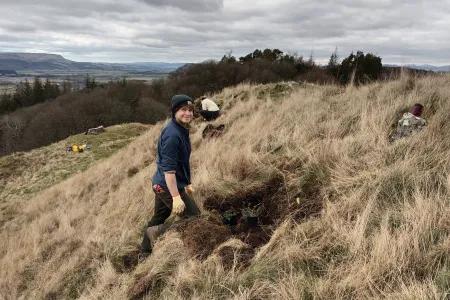 Student planting common rock-rose at Drumbrae
