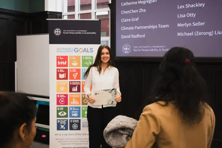 Changemakers hold certificates infont of SDG banner