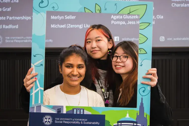 Trio of changemaker winners pose in SRS selfie frame