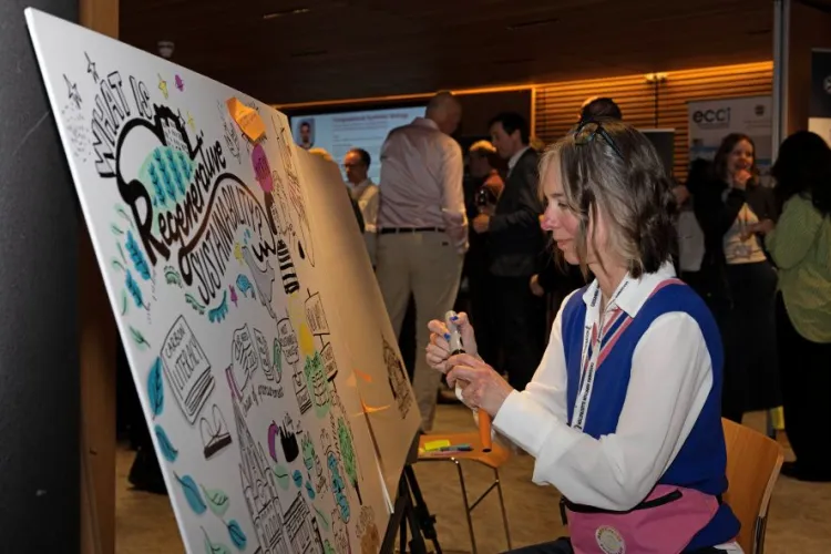 A person illustrating live on a large drawing board