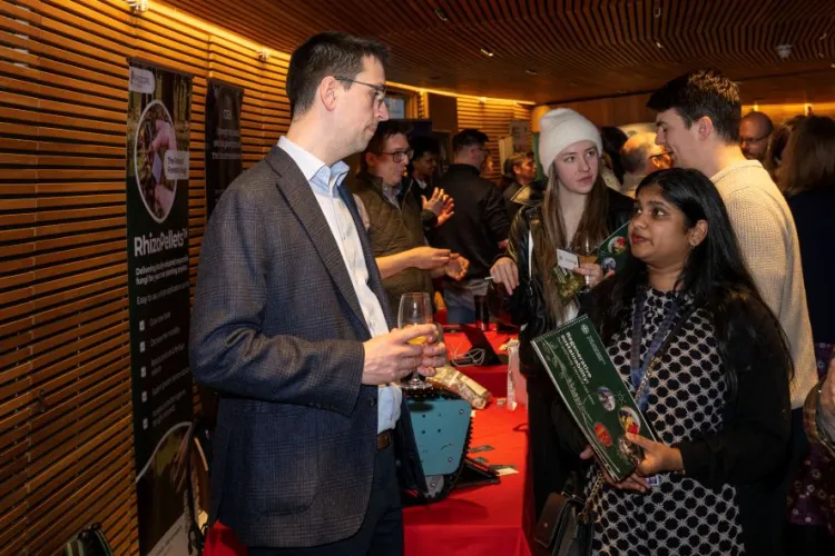 People talking to each other in a busy room