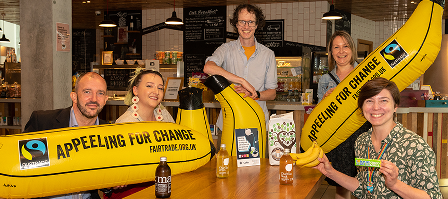 Fairtrade University Awards photoshoot Levels Cafe summer 2022. Inflatable bananas read: \"appeeling for change\"