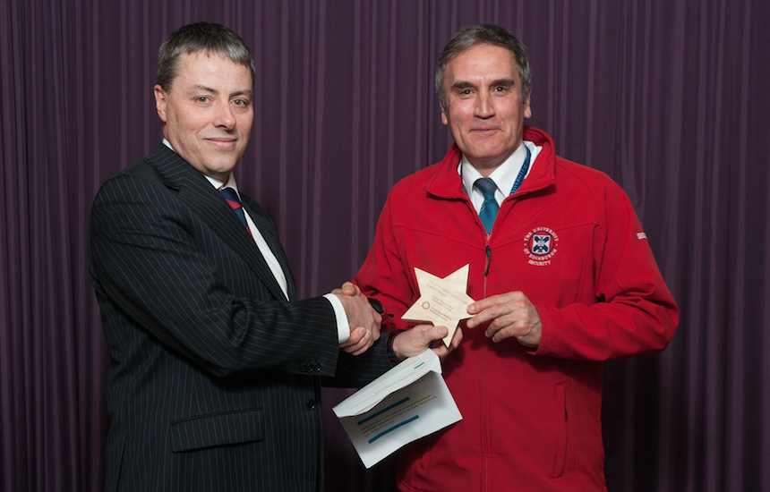 Frank Henzell picks up a Special Award for the Security team from Hugh Edmiston